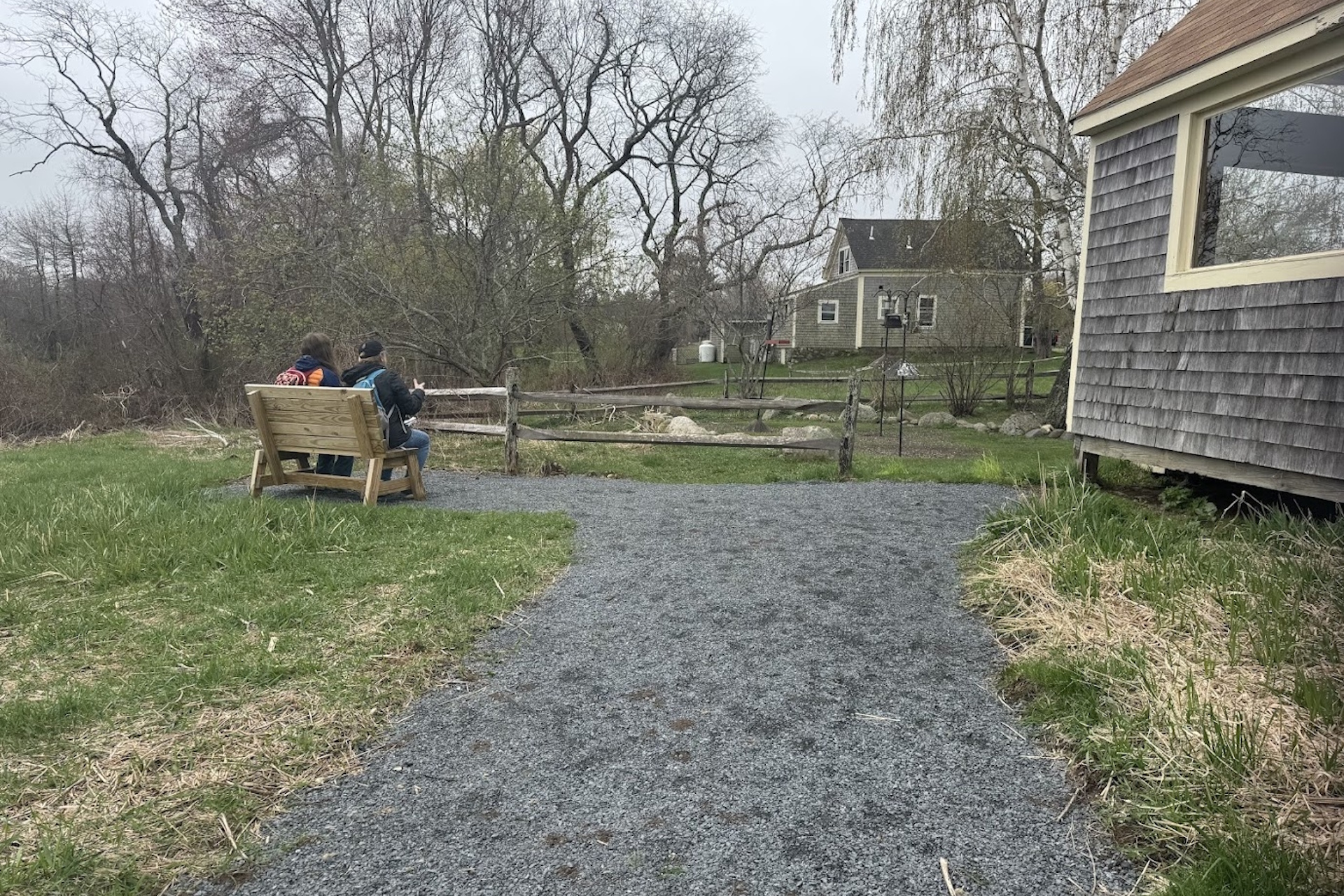 Two people birdwatching from a bench on the all persons trail