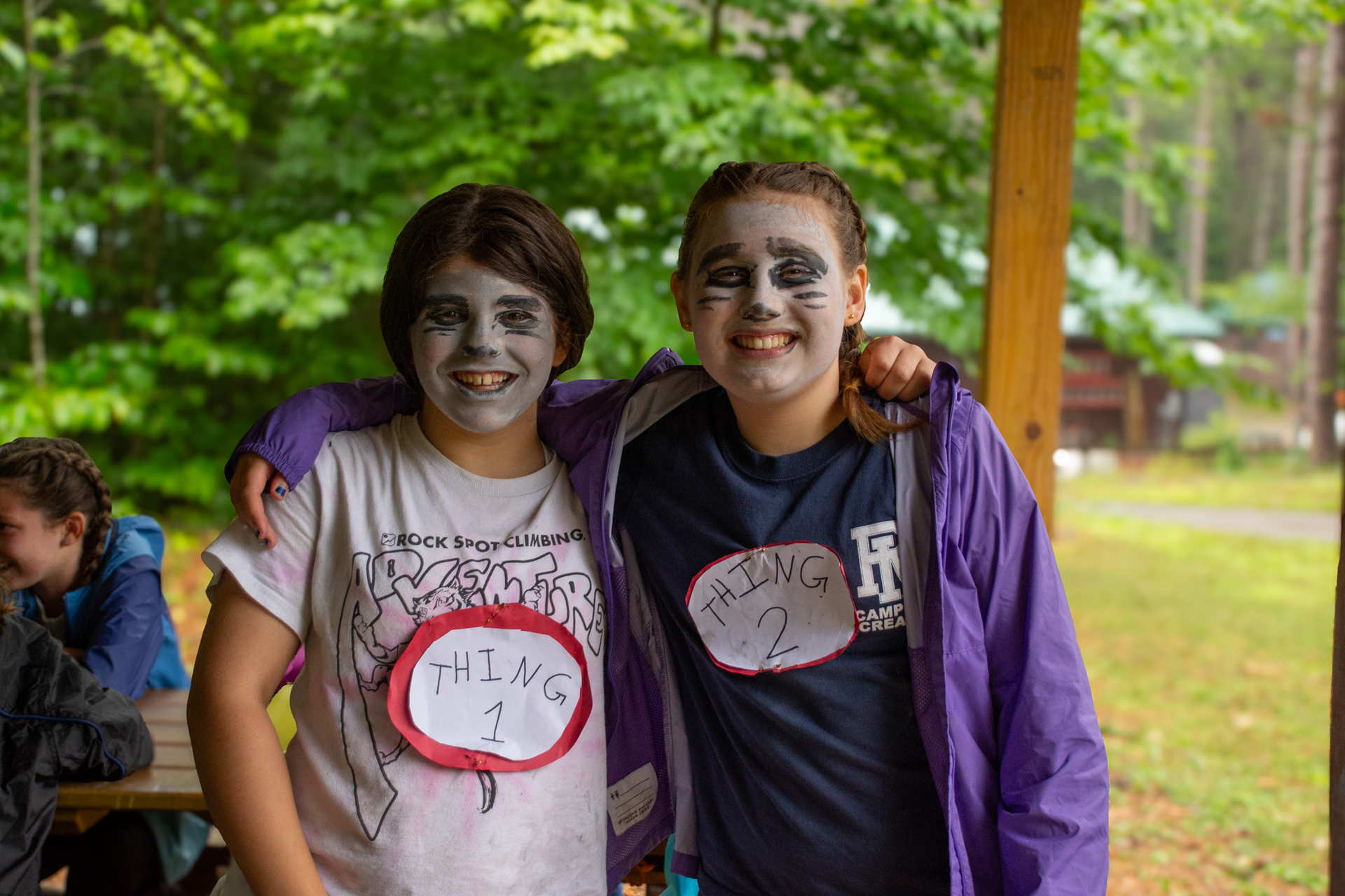 Two campers dressed up as dr. Seuss's thing one and thing two smile arm in arm.