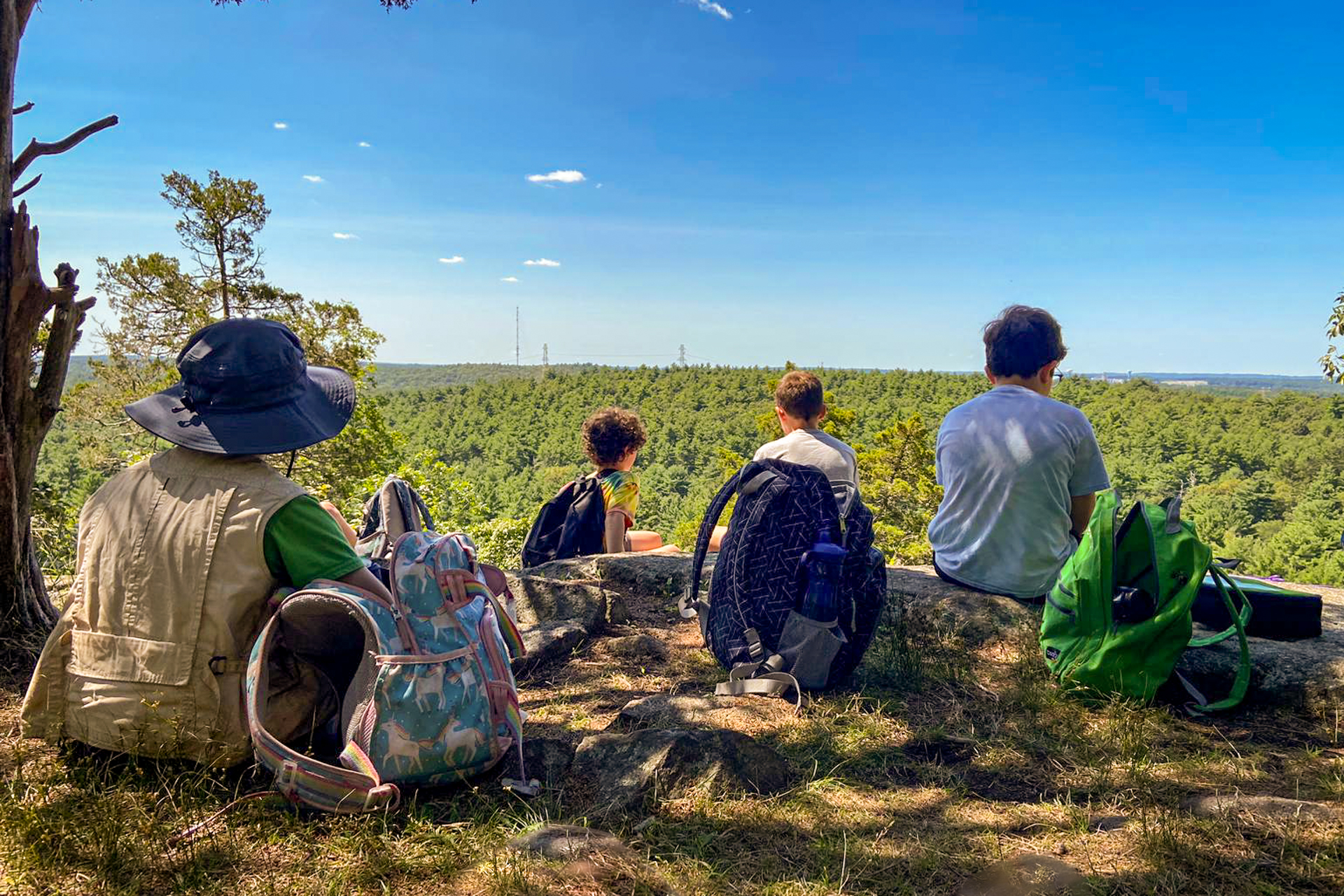 A group of Moose Hill campers taking a break at the Bluff Overlook at Moose Hill Wildlife Sanctuary