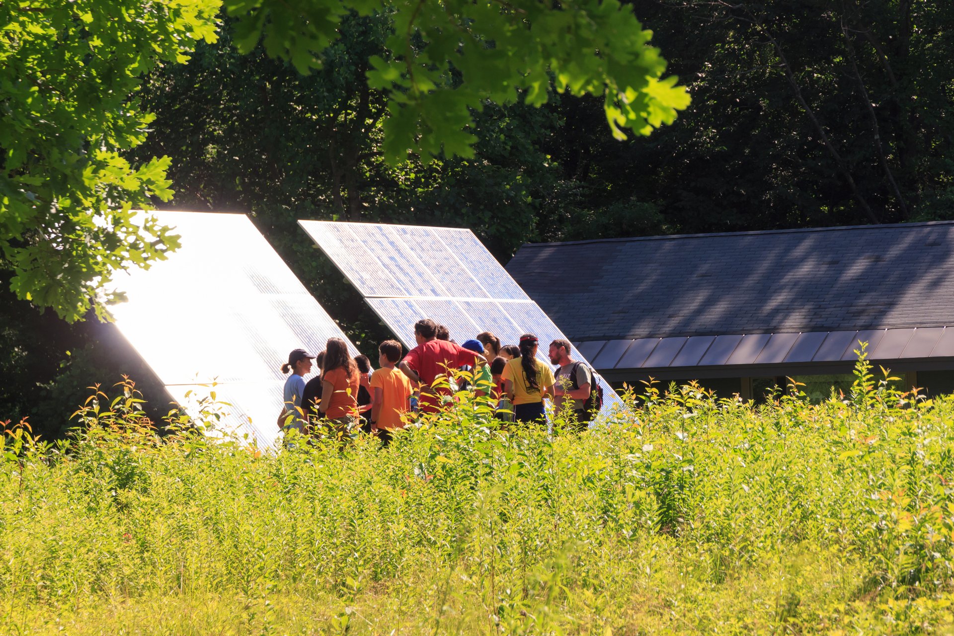 Group of people in front of solar panels