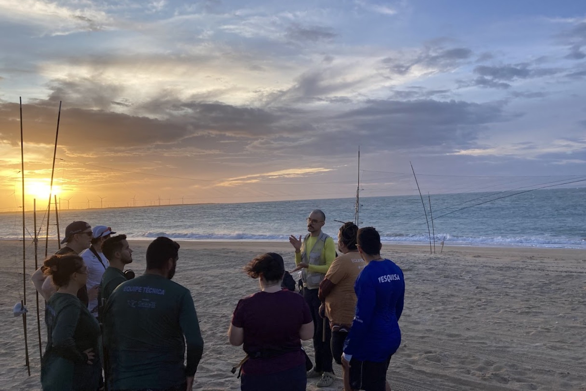 Group of people on the beach with sunset