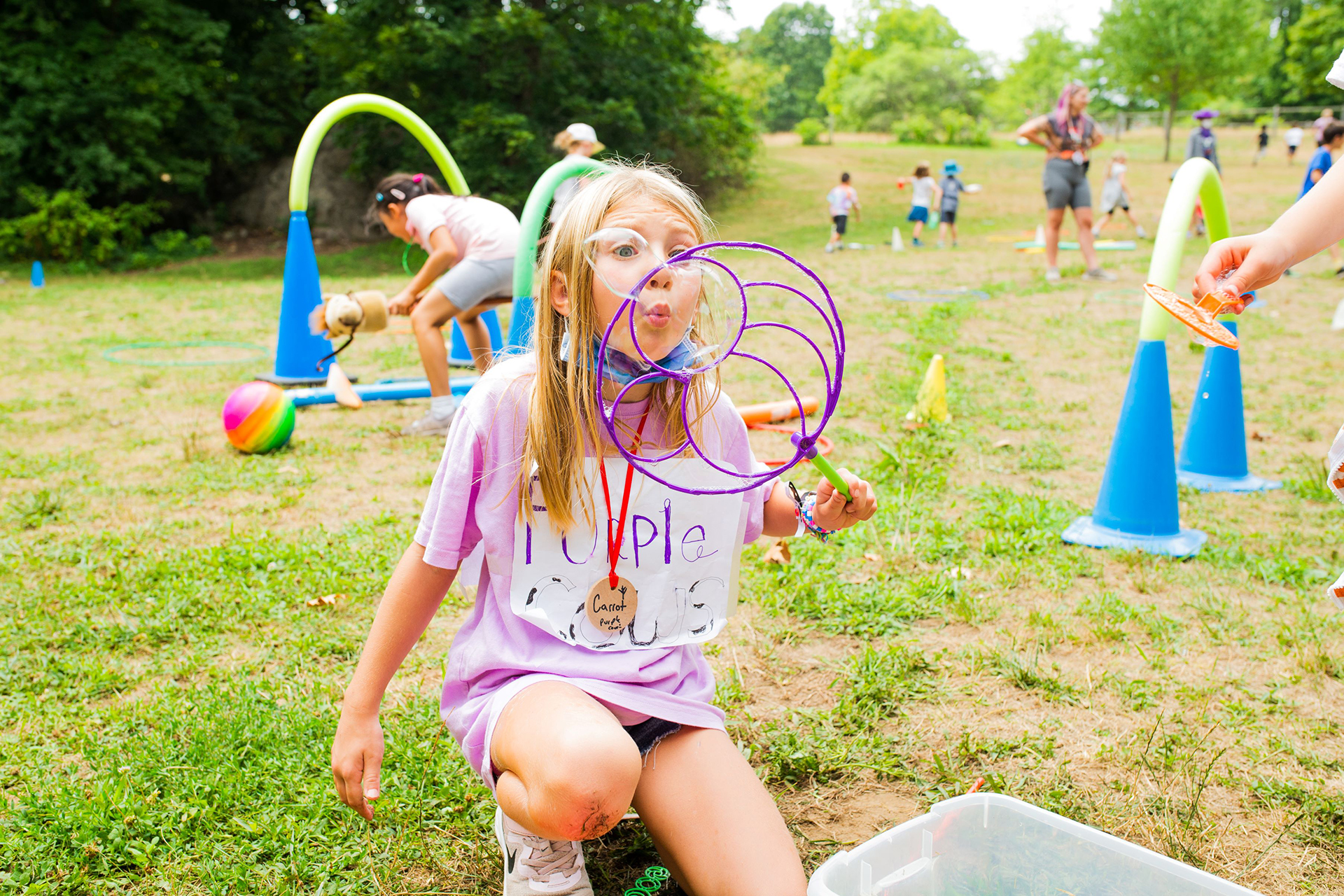 Camper blowing bubbles on a bright, sunny day