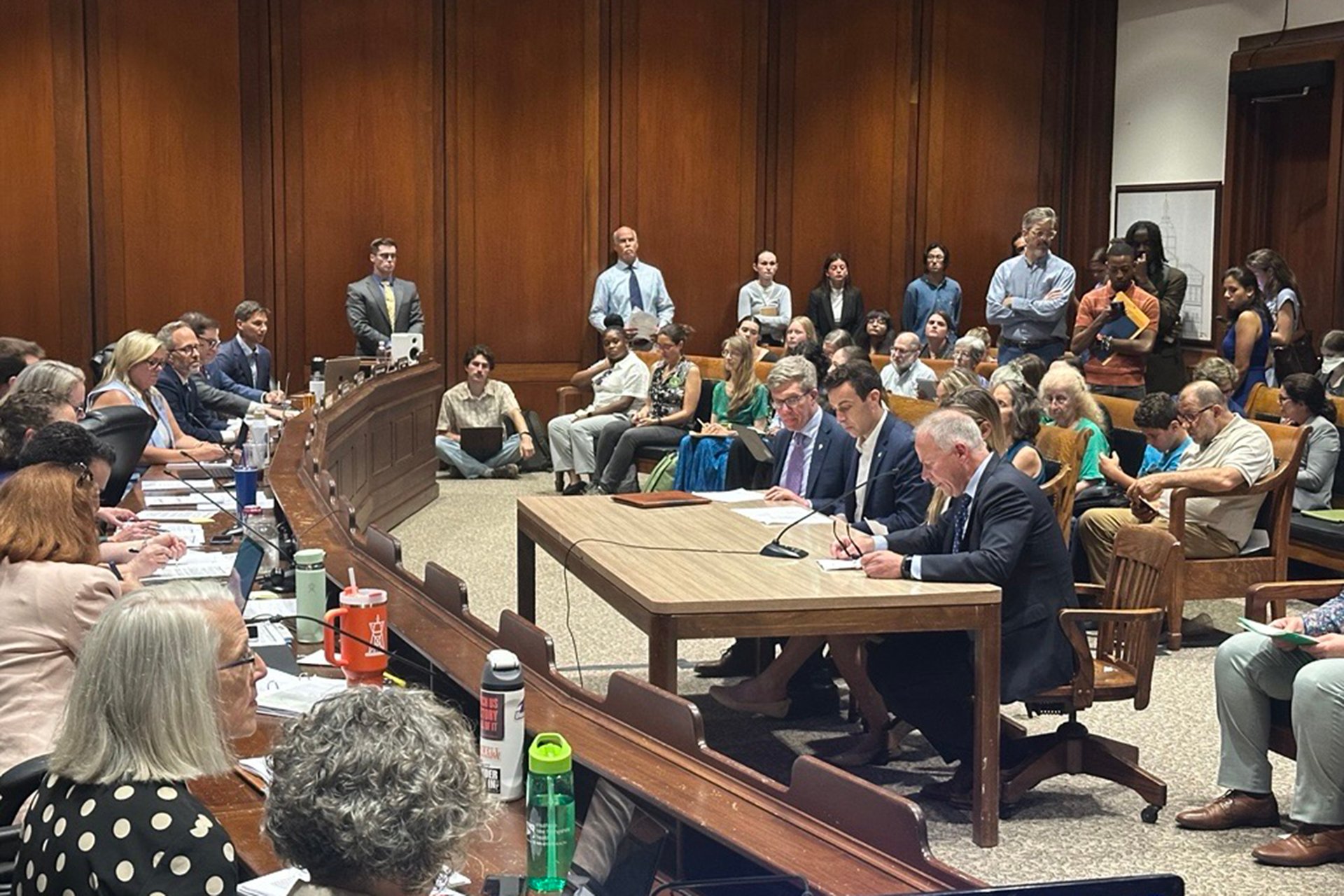 David O'Neill sitting at a table speaking into a microphone