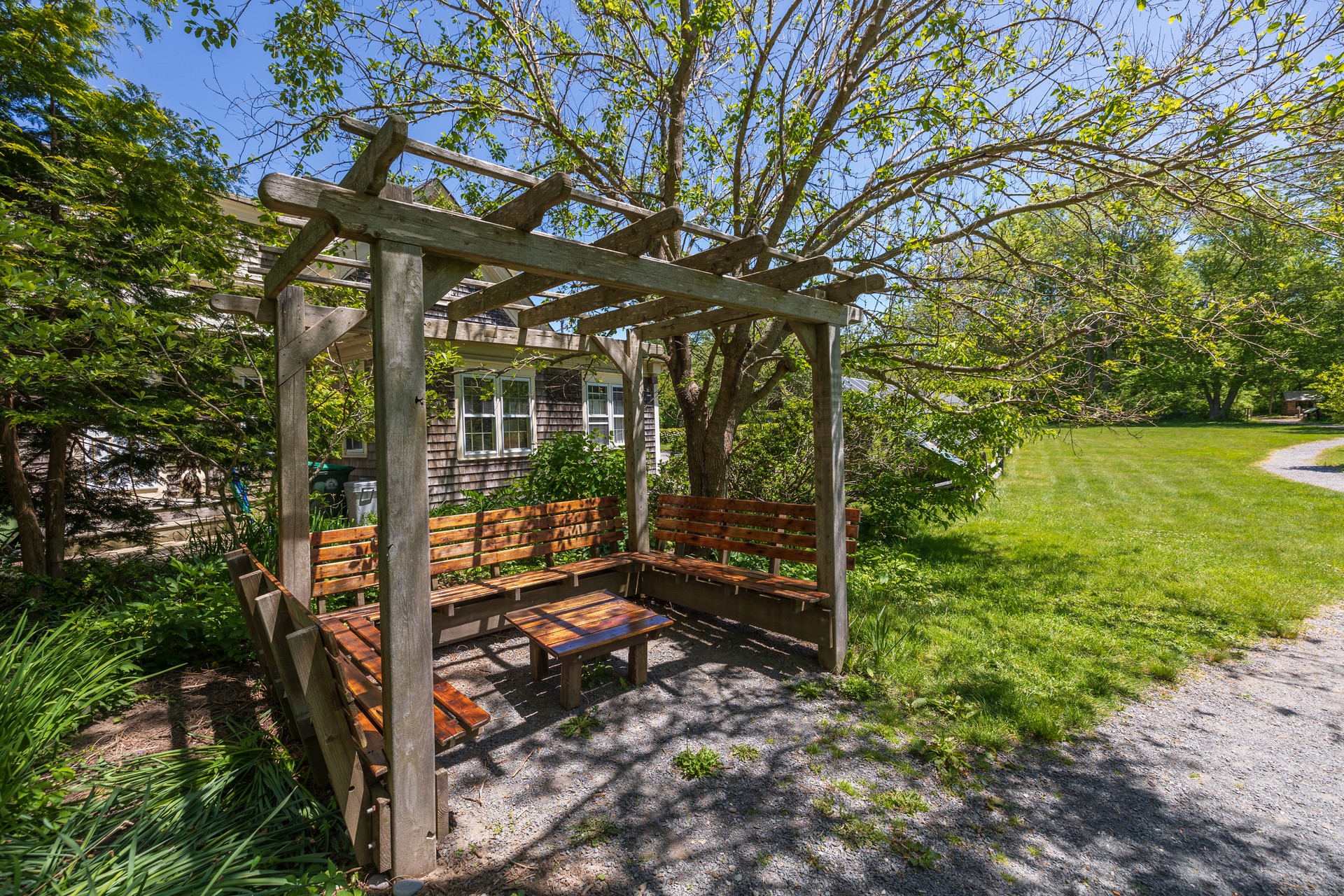 north shore table and benches under pergola