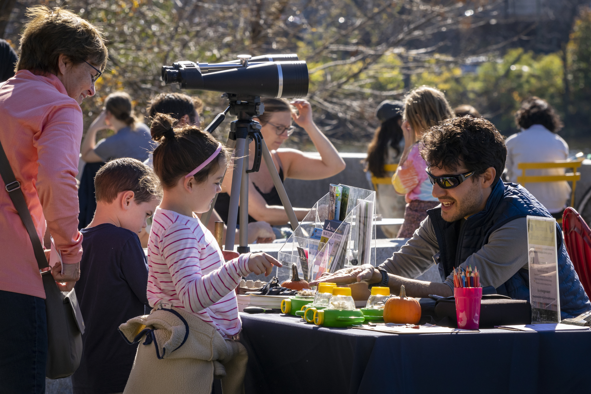 Children visiting a table outdoors at Magazine Beach's Nature in the City festival
