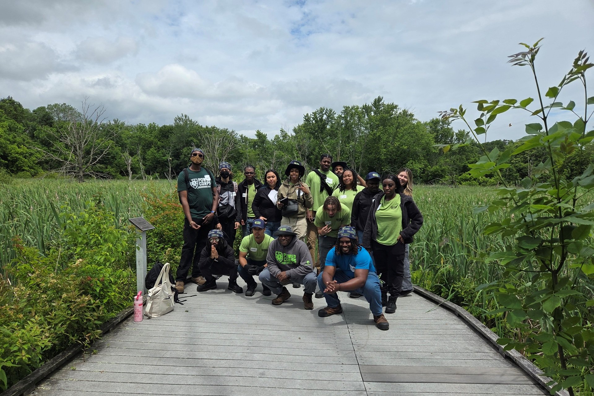 PowerCorpsBOS early-career interns posed for a group photo on a boardwalk