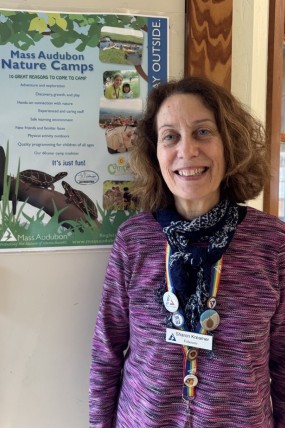 Sharon in front of camp sign