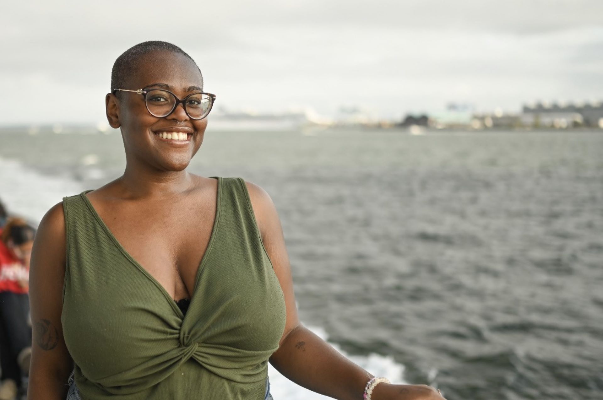 Uzoma Adichie, Climate Education Fellow, standing with water behind her.