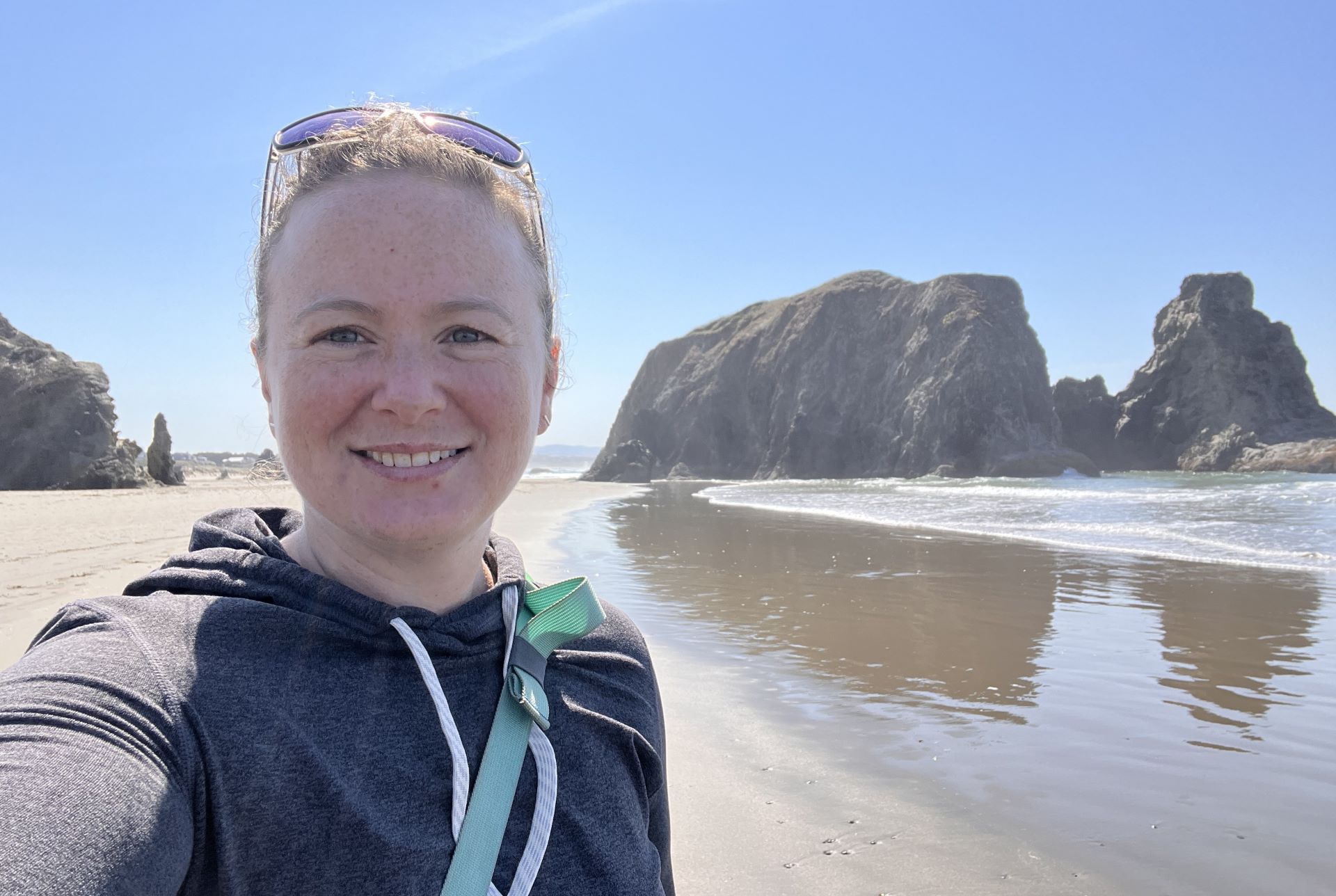 Marisa Abrahams smiling on a beach.
