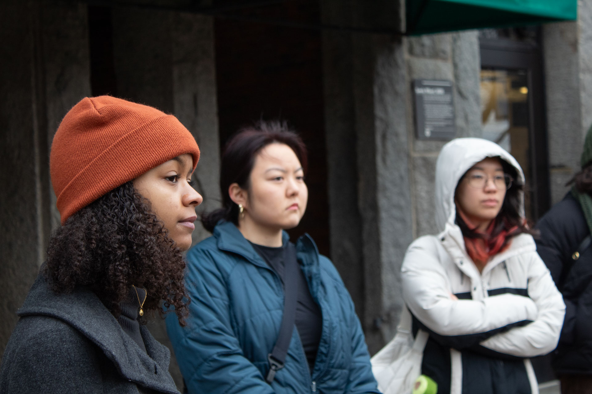 Three environmental fellowship program participants listen to a speaker.
