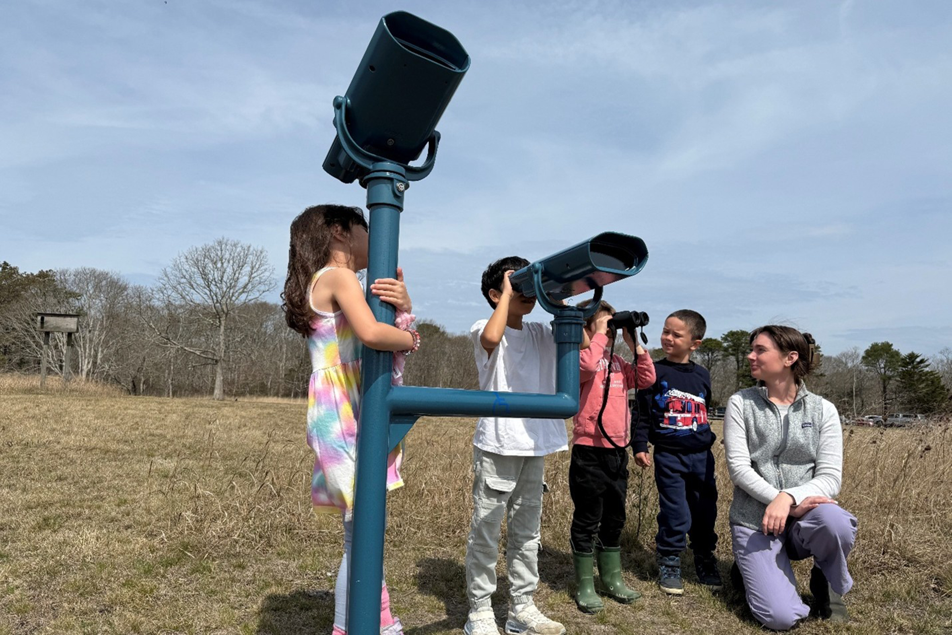 Children looking through stationary binoculars