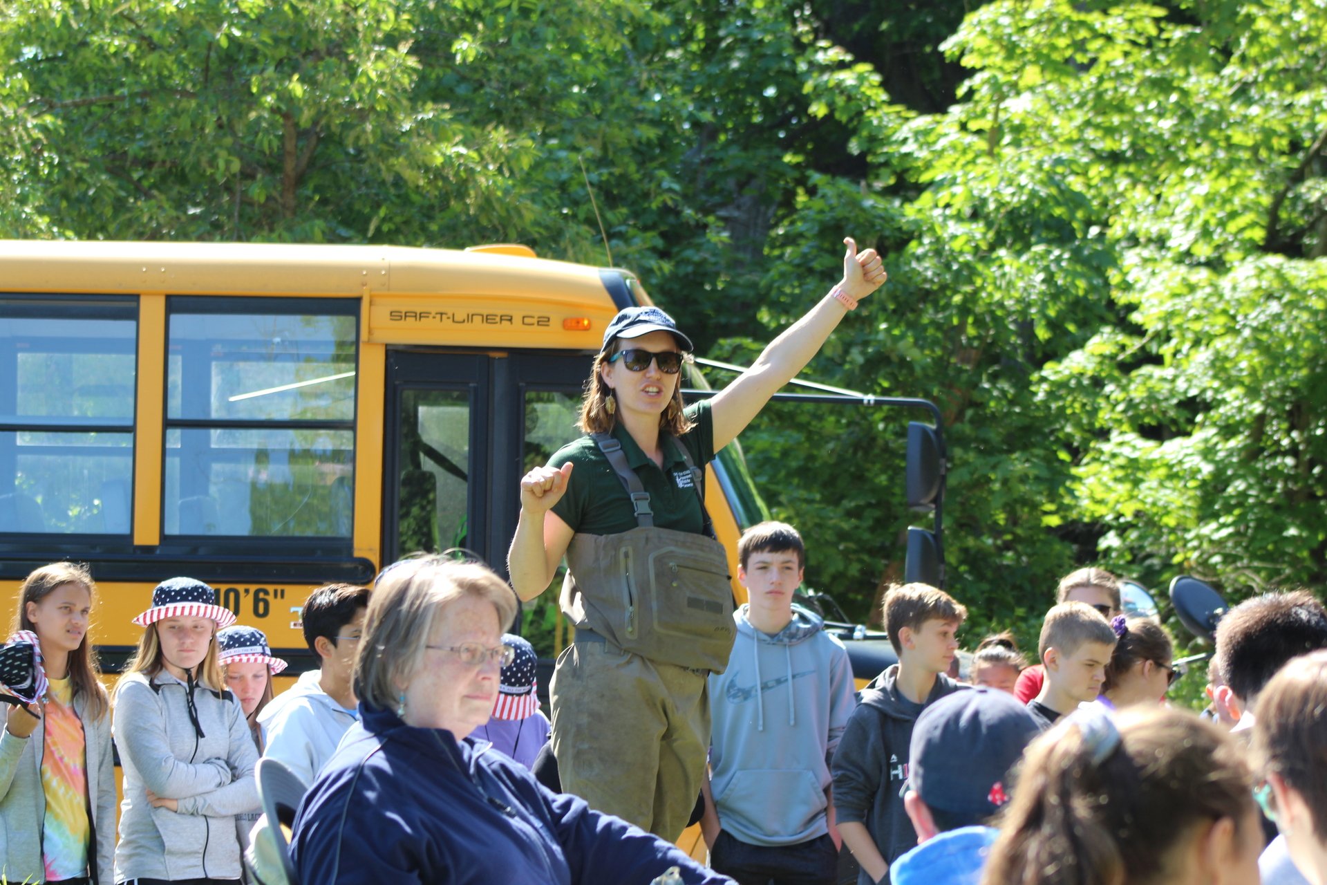 Students and Teacher with School Bus in background