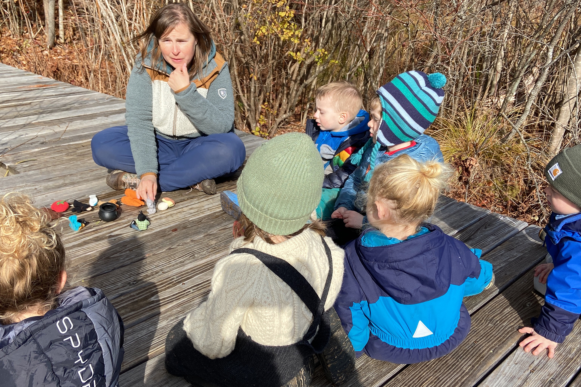 Preschoolers listening to a story on a boardwalk