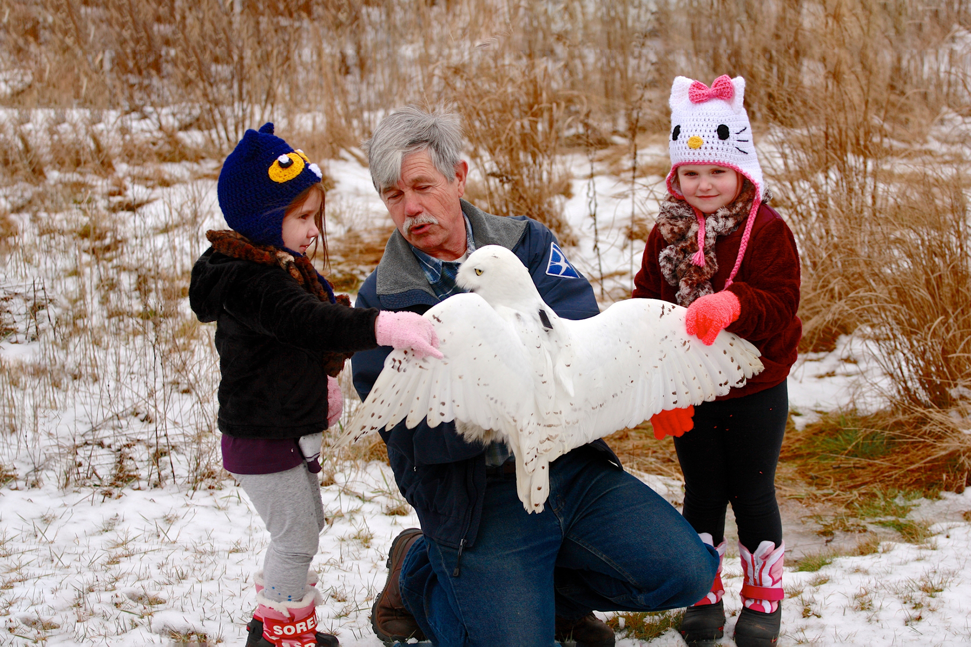 Norman Smith with snowy owl and his two grandchildren