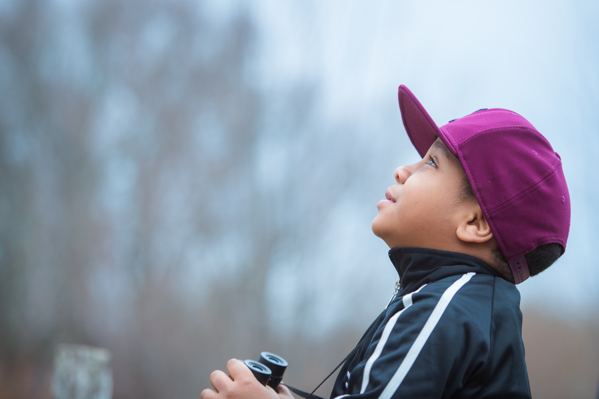 boy with binoculars looking up