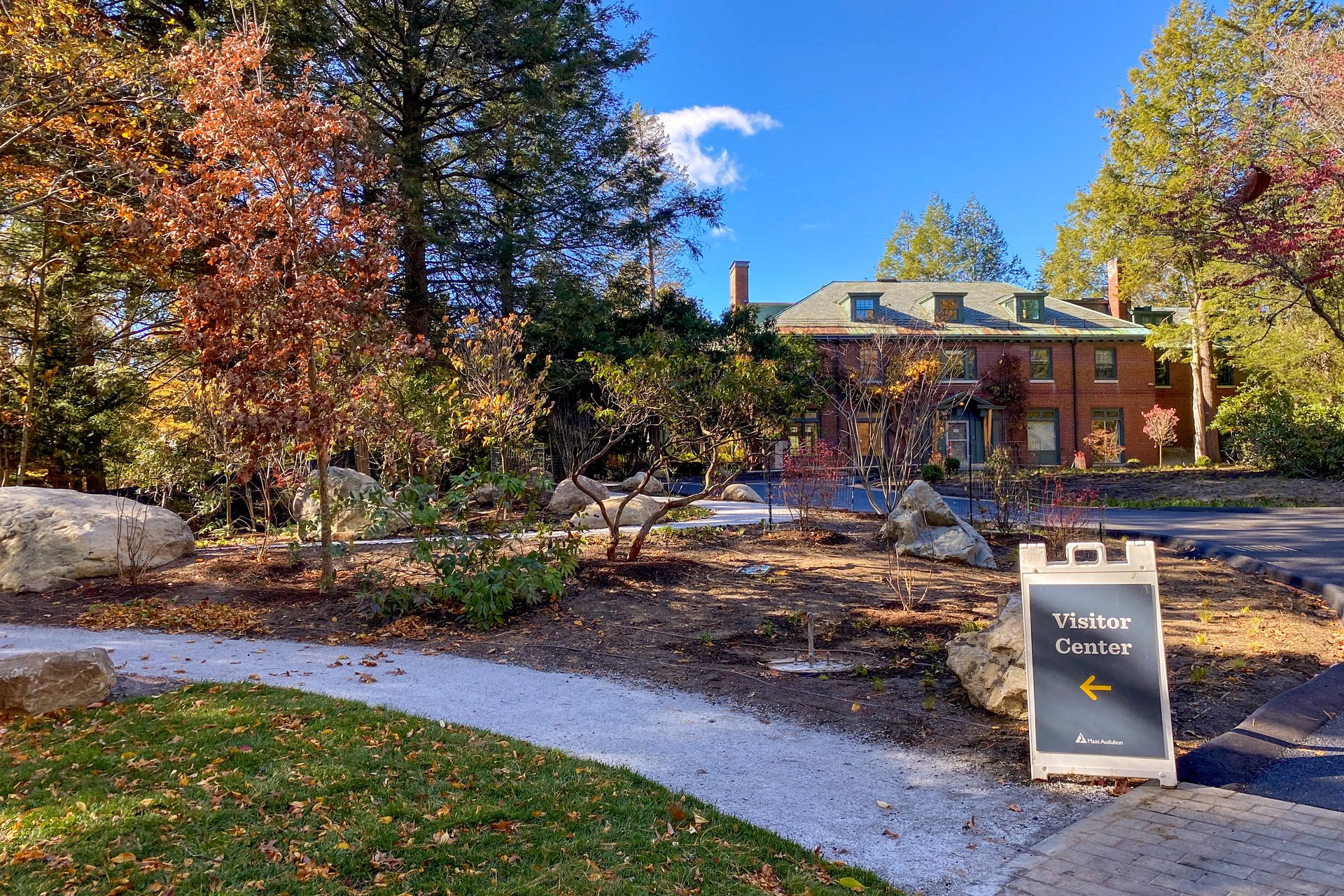 Habitat's entry circle after construction with sign pointing towards visitor center
