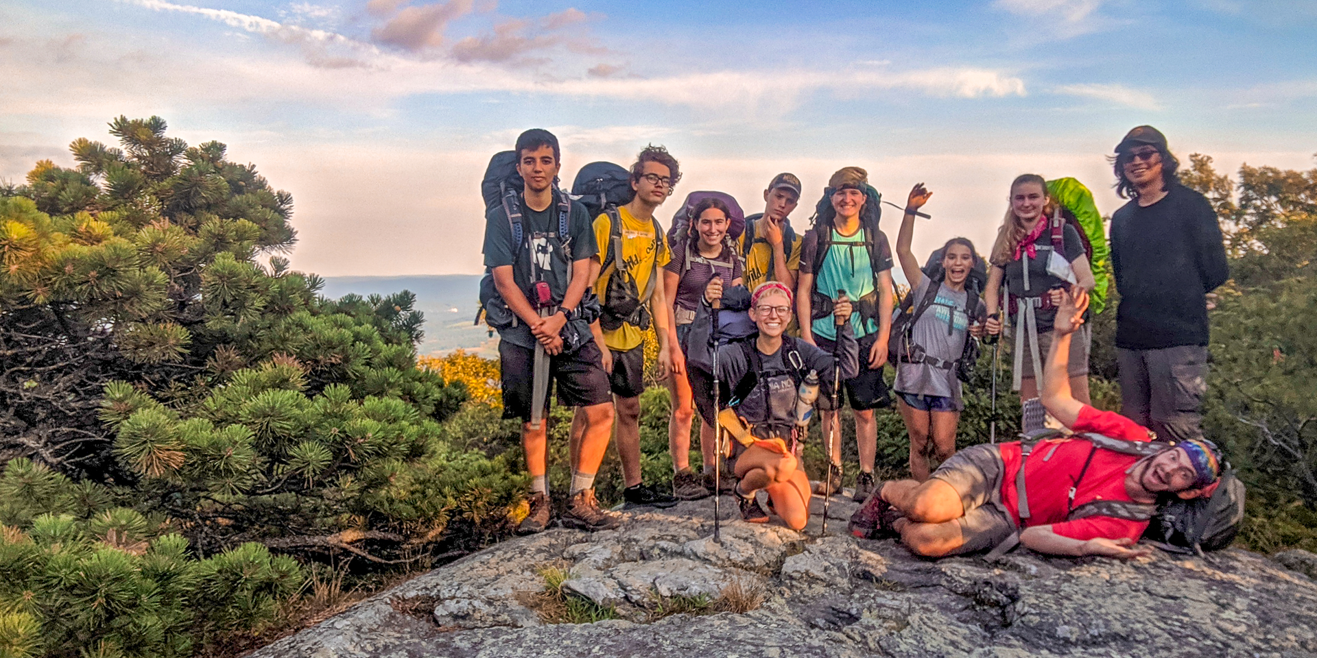 A group of teens posing at the top of a mountain in New Hampshire during a backpacking trip with Mass Audubon's Teen Adventure Trips program