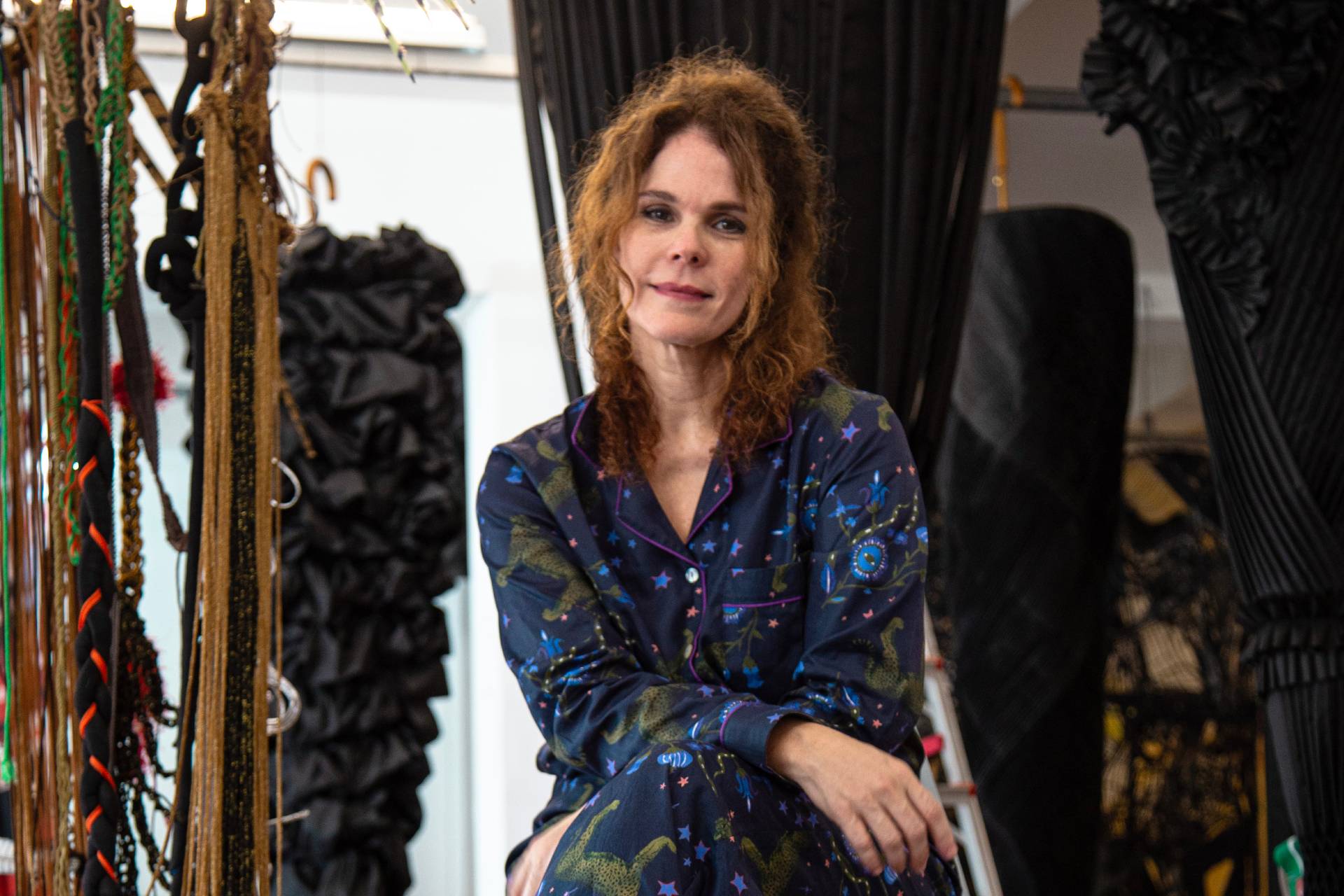 Laura Lima seated with arms crossed over her lap