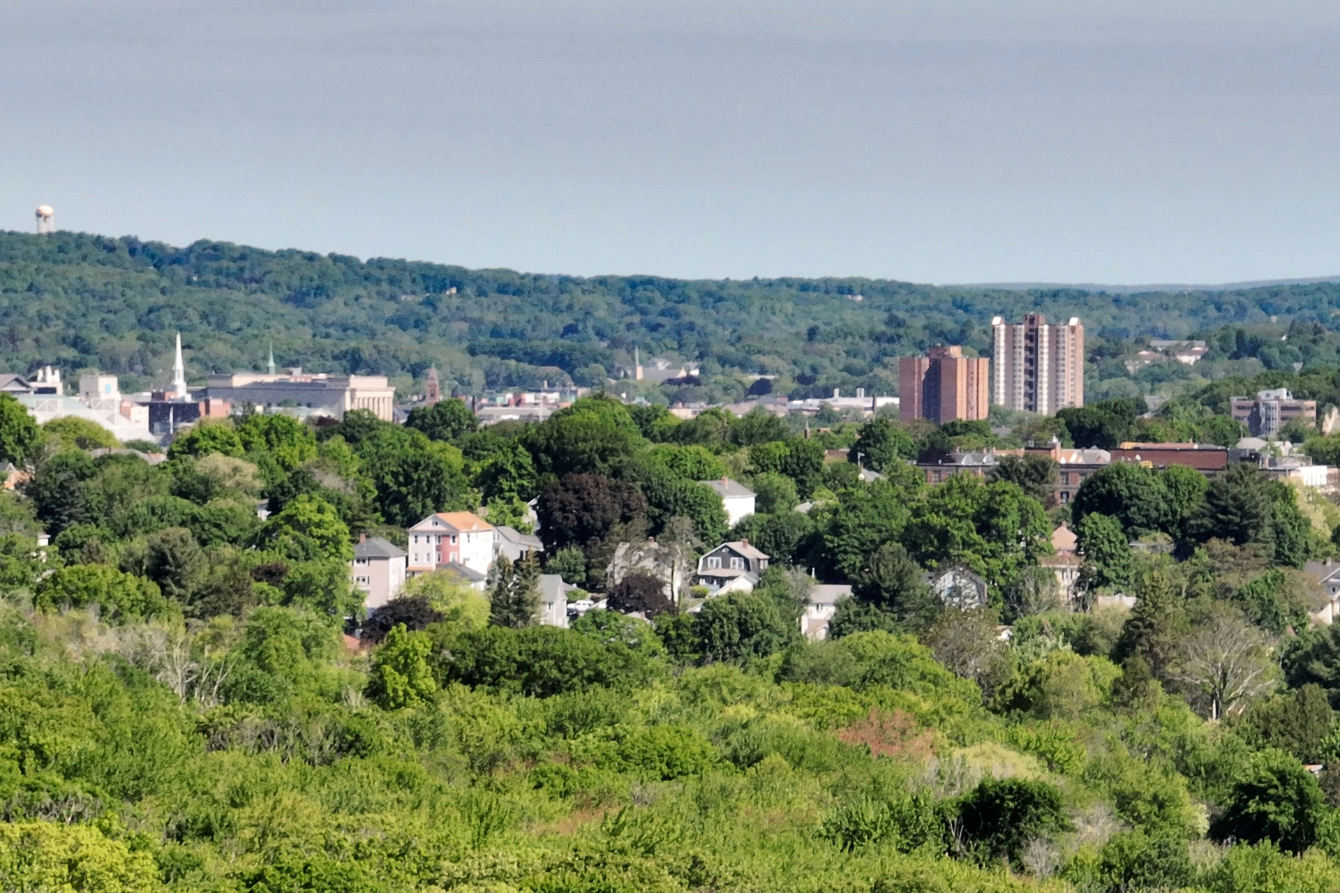 drone shot of Worcester skyline with trees and houses