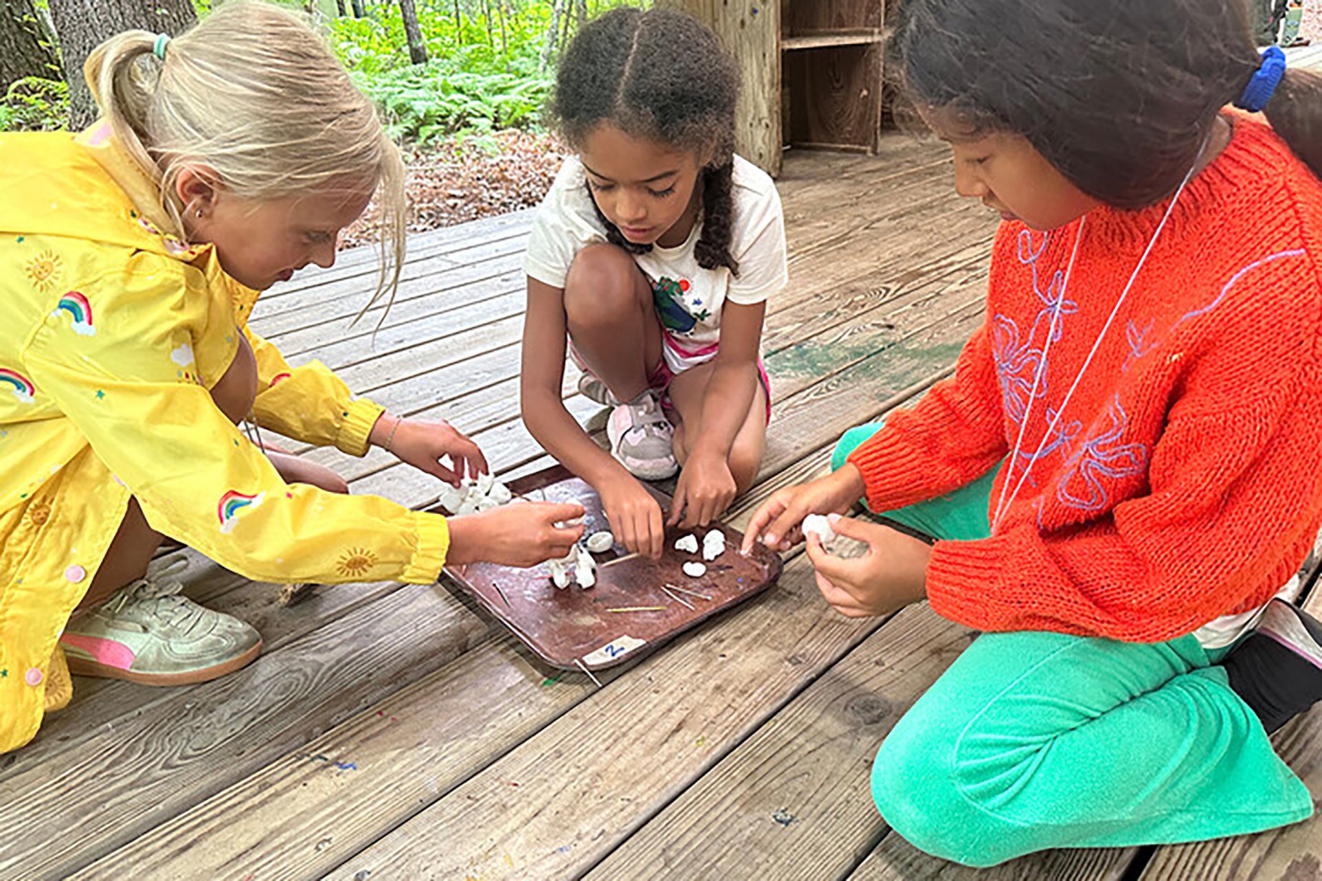 Campers building a tower with marshmallows and toothpicks