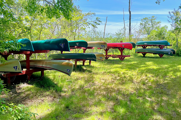 Canoes on racks along the Ipswich River trail