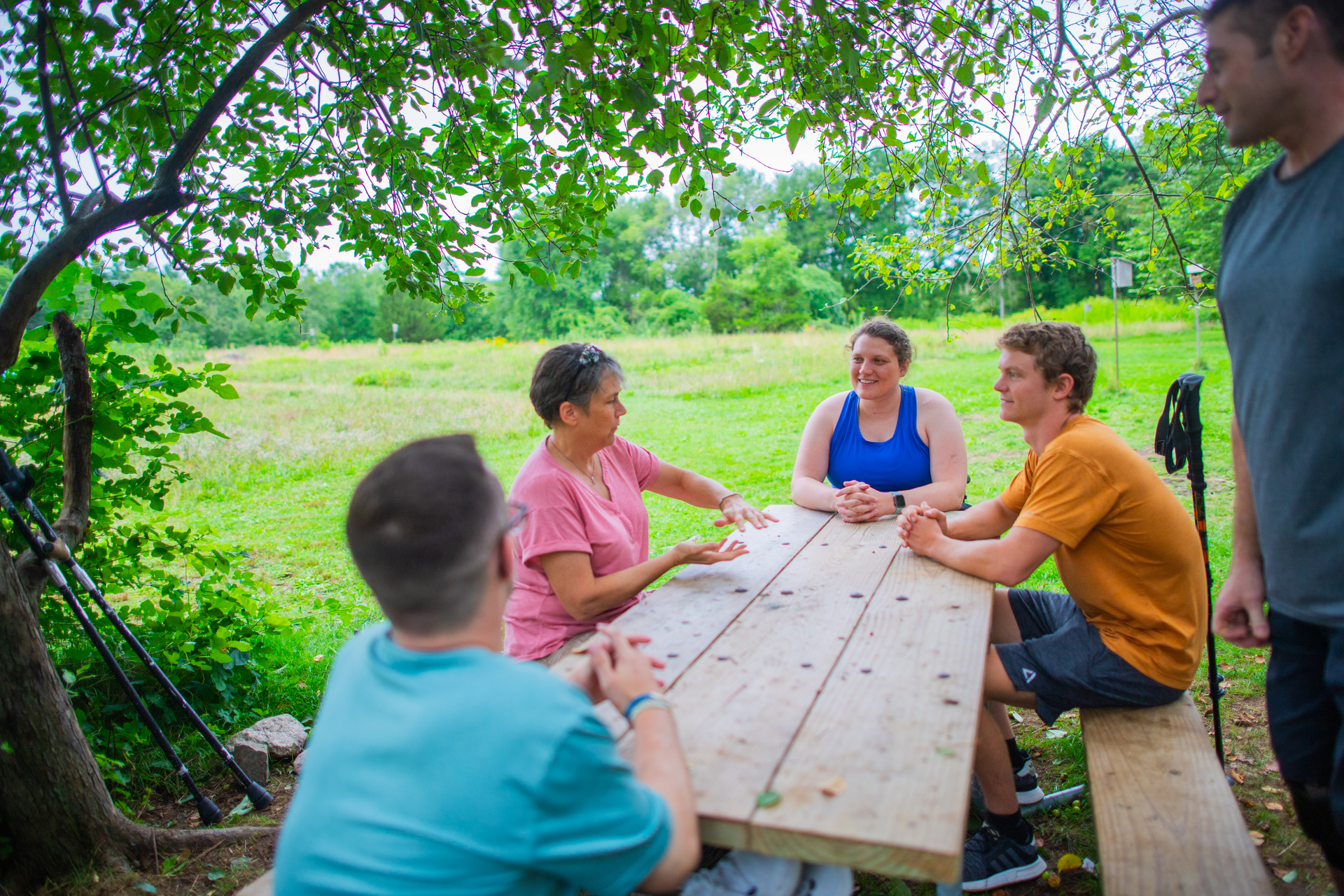 adults sitting around picnic table