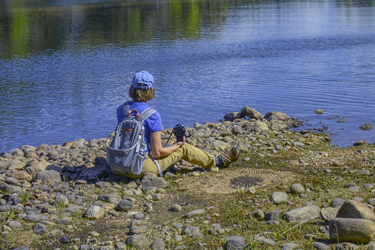 Person sitting by a lake in New Salem, MA © Rachel Bellenoit