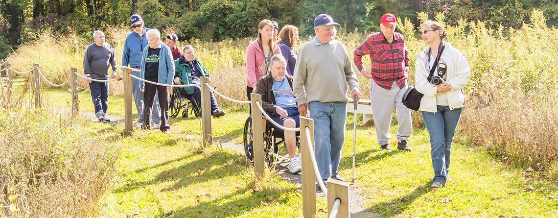 Group exploring an accessible trail at Arcadia Wildlife Sanctuary