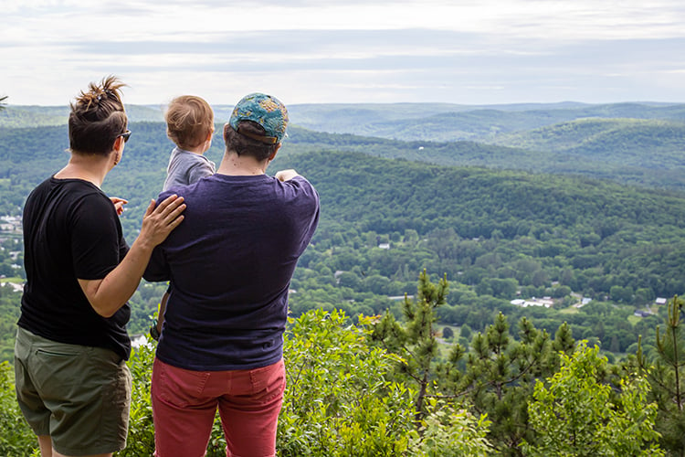 Parents & infant looking gazing out from an overlook at High Ledges Wildlife Sanctuary in spring © Phil Doyle