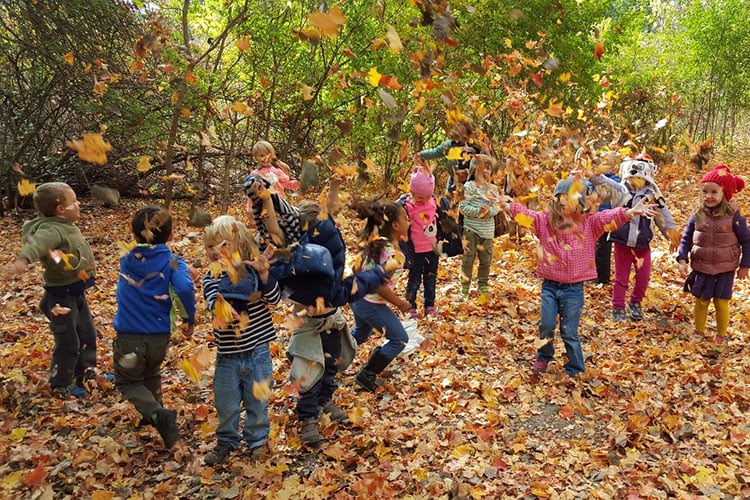 BNC preschoolers playing in fall leaves
