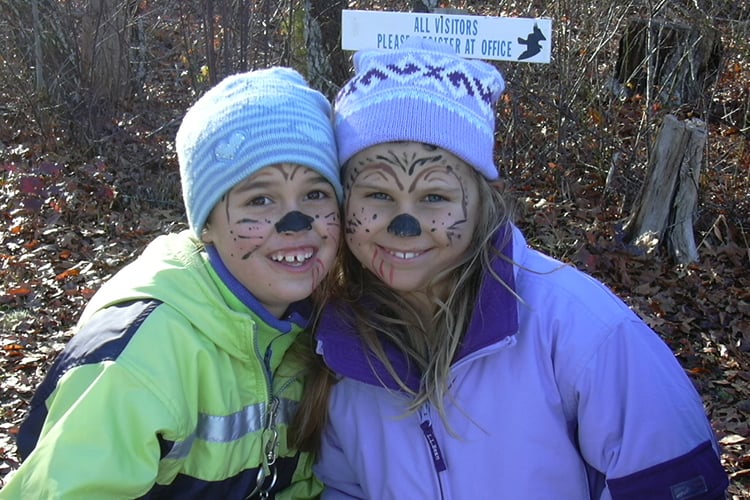 Two girls with face paint at Felix Neck's annual Fall Fest