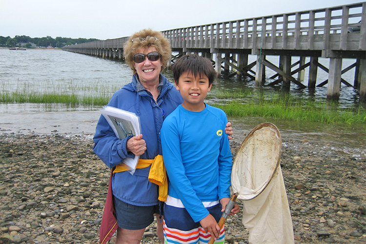 Boy with seining net at Duxbury Beach