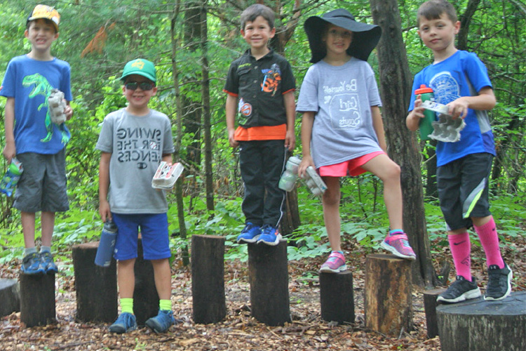 Oak Knoll campers standing on balance logs