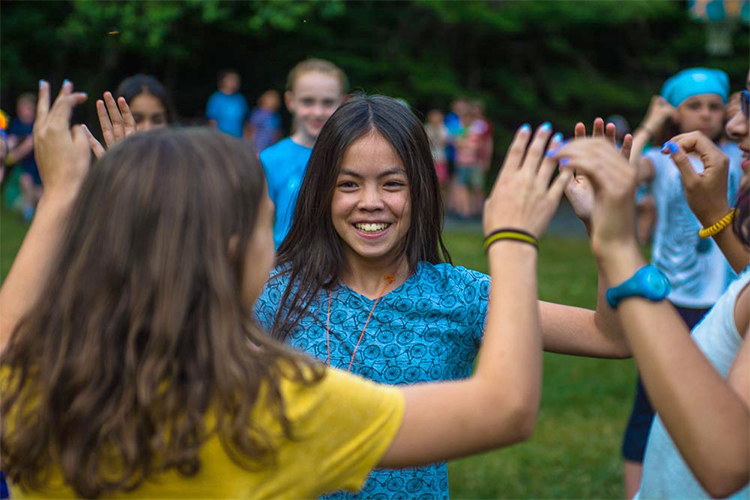 Campers playing the circle game outside